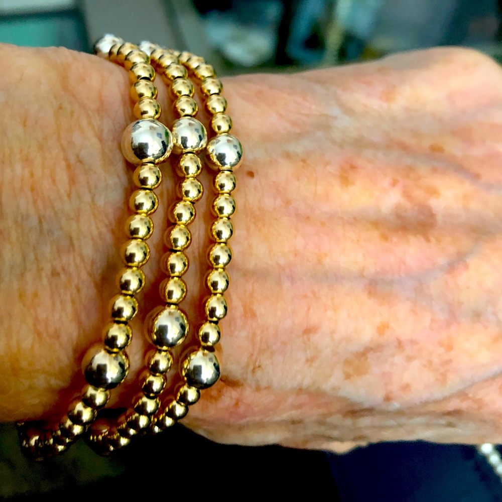 Triple wrap elastic bracelet/necklace with gold filled beads.